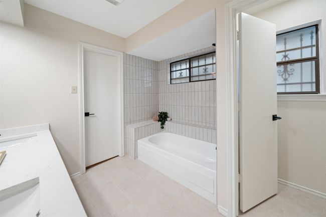 Full bath featuring double vanity, baseboards, tile patterned flooring, and a sink | Image 16