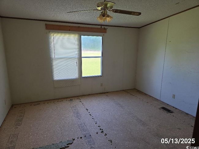 Unfurnished room with a textured ceiling and ceiling fan | Image 21