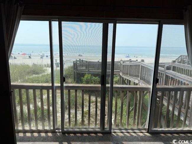 Unfurnished sunroom with view of water and beach and plenty of natural light | Image 15