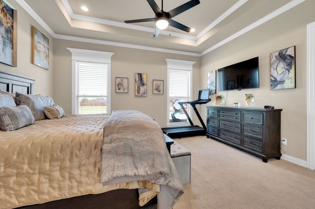 Bedroom featuring ornamental molding, light carpet, a tray ceiling, recessed lighting, and a ceiling fan | Image 18