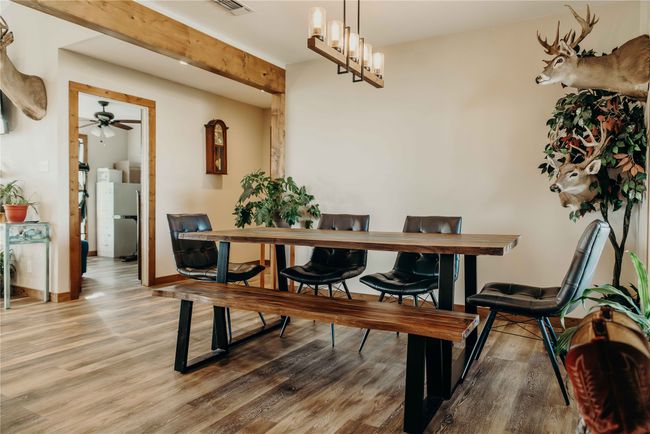 Dining area with wood finished floors and ceiling fan | Image 17