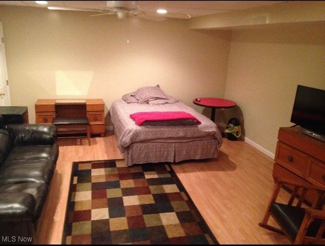 Bedroom with ceiling fan and wood-type flooring | Image 9