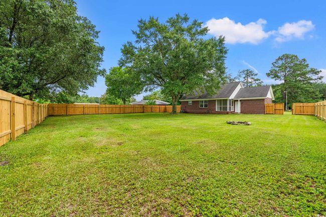 View of fenced backyard | Image 32