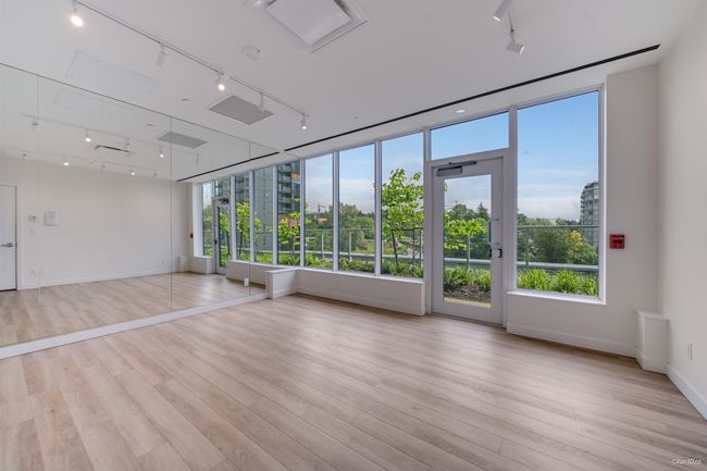 Empty room with track lighting, healthy amount of natural light, wood finished floors, and baseboards | Image 14