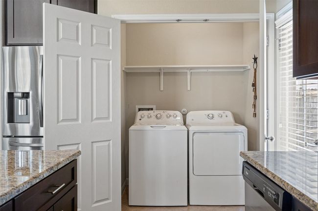 The laundry closet is accessible on the main level with a shelf for your laundry essentials. | Image 12