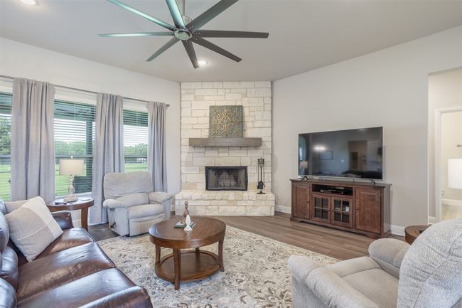Stone Fireplace provides the focal point of the open living space. | Image 6