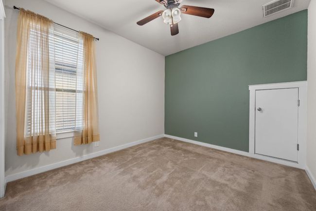 Empty room with a ceiling fan, carpet flooring, and baseboards | Image 24