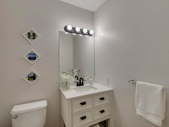 Half bathroom featuring toilet and vanity | Image 16