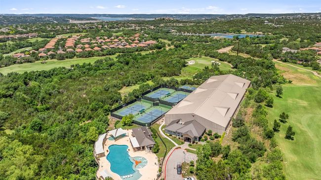 Aerial perspective of suburban area with a local golf course, a large body of water, and a pool | Image 39