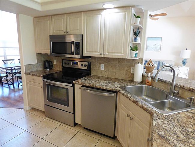 the kitchen is a delight for the chef, counter top have been replace in 2018m wide farm sing, new appliances in 2018, breakfast bar, tiled back splash, open ceiling with recessed light | Image 23