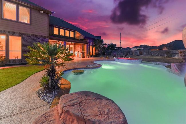 This large backyard offers ample space for fun and activities, even with the pool and spa in place. There's plenty of room for additional toys like trampolines and playsets, or for pursuing gardening and other hobbies. | Image 4