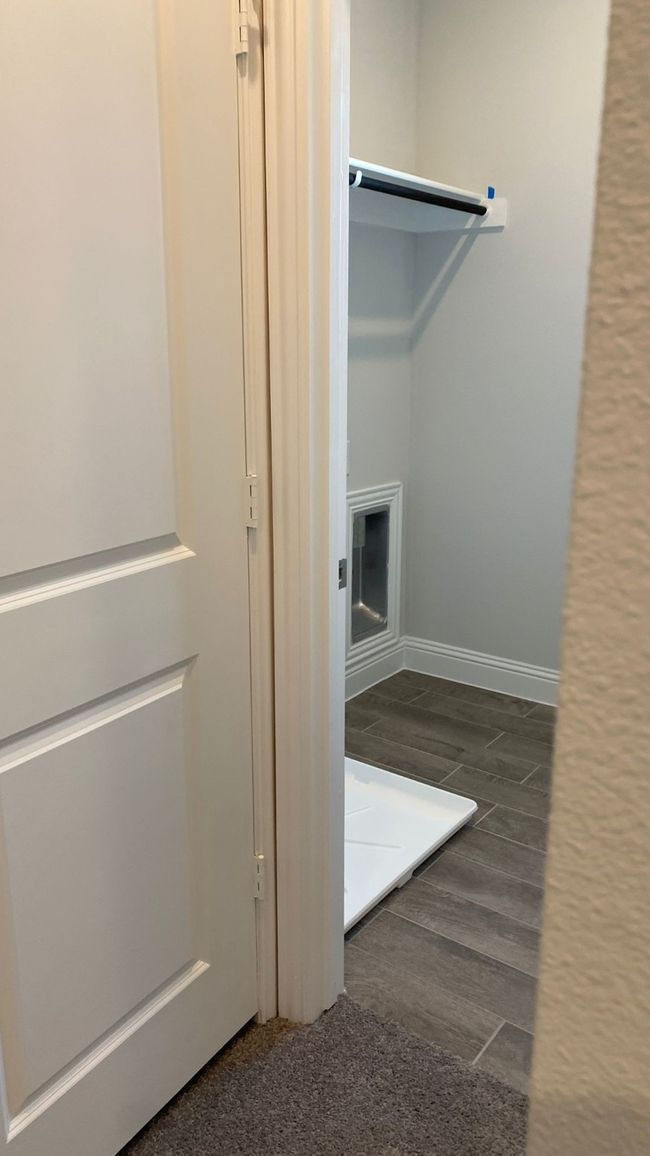 Laundry area featuring wood finished floors and baseboards | Image 7