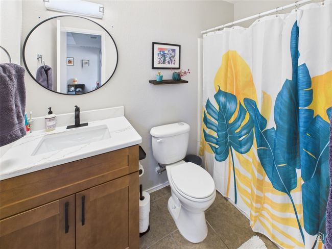 Full bathroom featuring vanity, tile patterned floors, an AC wall unit, and curtained shower | Image 28