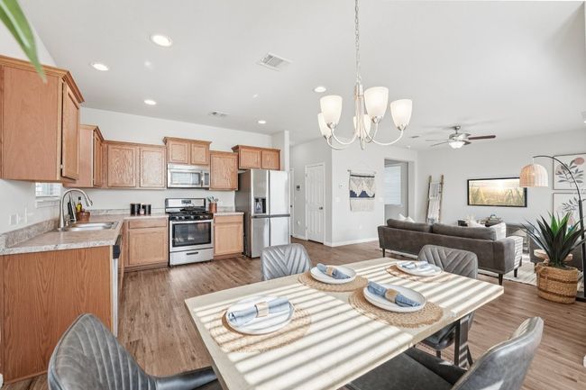Dining space with a chandelier, recessed lighting, wood finished floors, and ceiling fan | Image 11