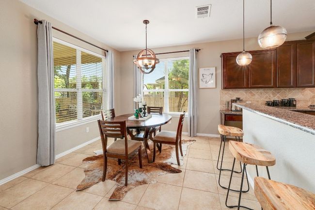 Positioned perfectly between the living and kitchen, the breakfast area offers a cozy spot to enjoy your morning coffee while staying connected to the heart of the home | Image 16
