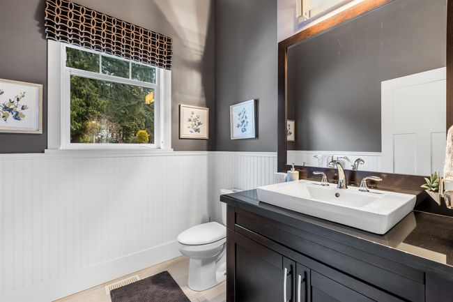 Bathroom with wainscoting, visible vents, toilet, and vanity | Image 14