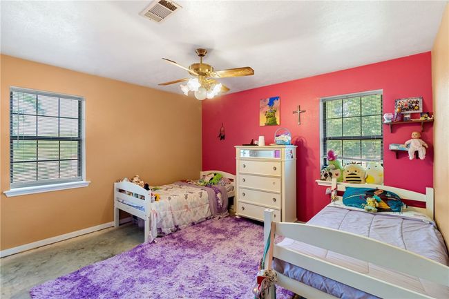 Carpeted bedroom with ceiling fan and baseboards | Image 27