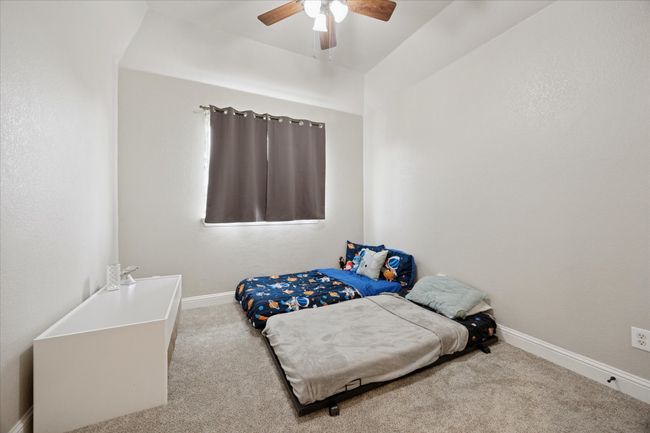 Bedroom featuring carpet, baseboards, and a ceiling fan | Image 19