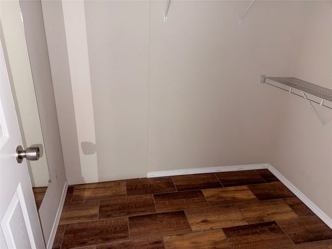Walk in closet with wood finished floors | Image 18