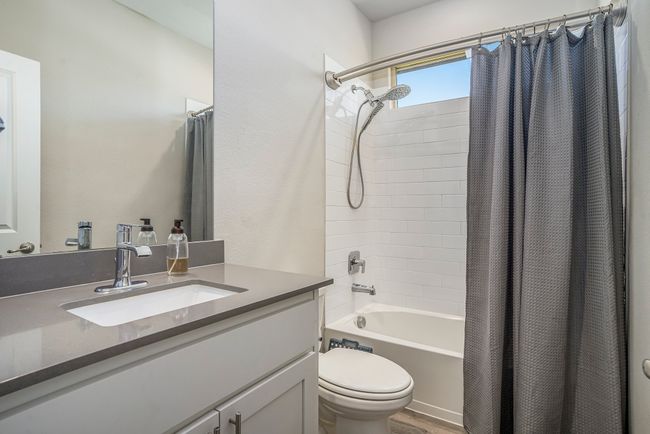 Bathroom featuring toilet, vanity, and shower / tub combo with curtain | Image 15