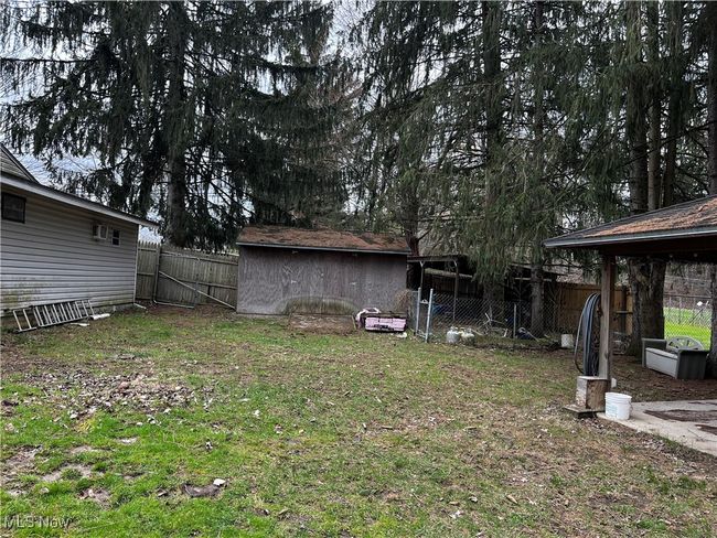 View of yard with fence and an outdoor structure | Image 16