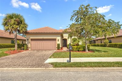 Mediterranean / spanish-style house with a garage and a front lawn | Image 2