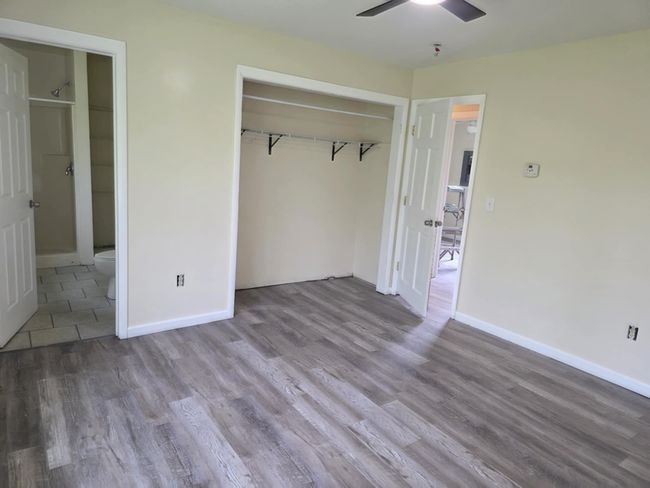 Unfurnished bedroom featuring wood finished floors, a closet, and a ceiling fan | Image 20