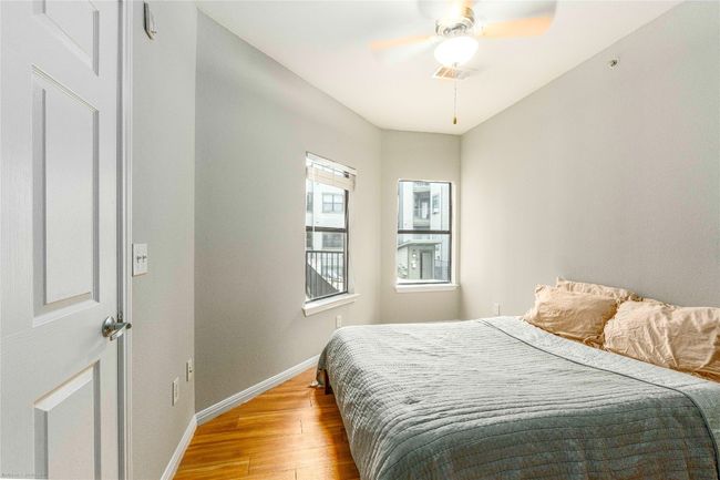 Bedroom with light wood-type flooring and a ceiling fan | Image 7