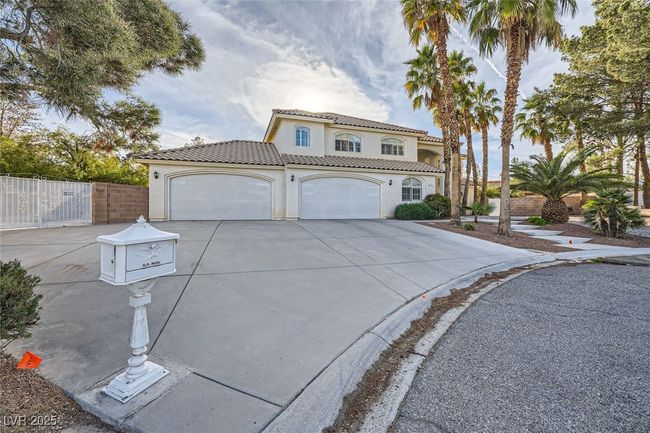 Mediterranean / spanish-style house with concrete driveway, a tiled roof, an attached garage, fence, and stucco siding | Image 17