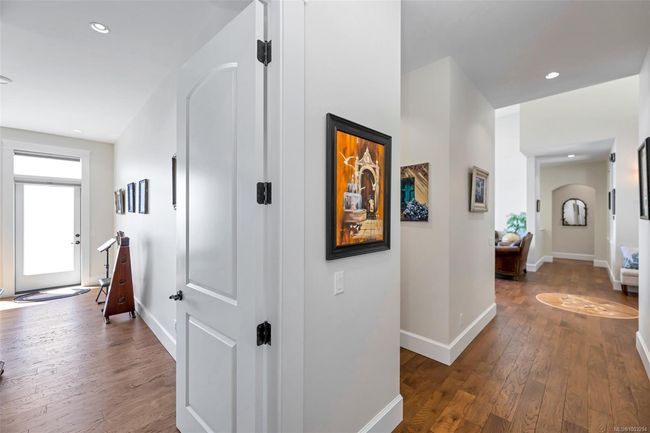 Hallway featuring wood-type flooring, arched walkways, and recessed lighting | Image 79