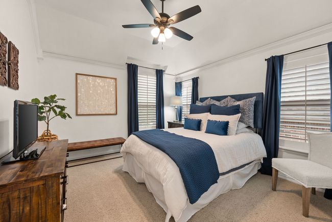 Upstairs Bedroom with vaulted ceiling, crown molding, ceiling fan, walk in closet and carpeted flooring. | Image 29