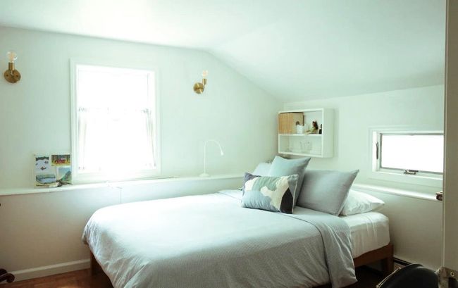 Bedroom featuring a baseboard radiator and lofted ceiling | Image 11