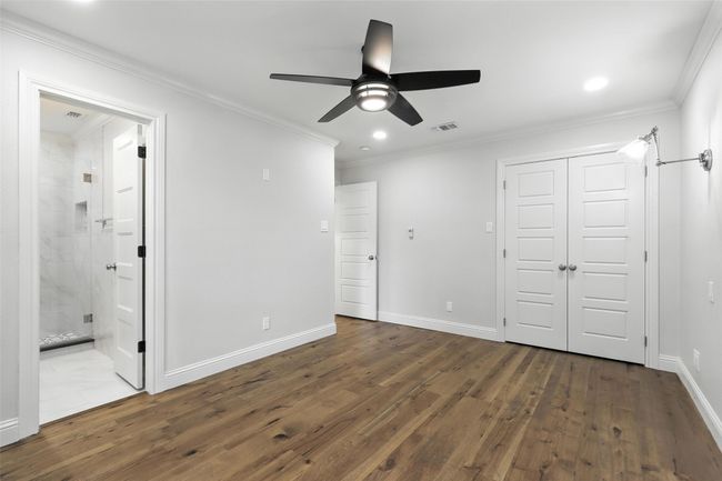 Unfurnished bedroom with wood-type flooring, ornamental molding, recessed lighting, a closet, and ceiling fan | Image 31