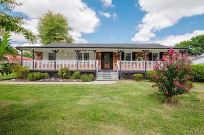 Single story home with a front lawn, ceiling fan, and covered porch | Image 2