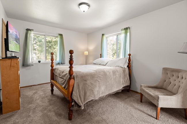 Carpeted bedroom with multiple windows and baseboards | Image 18
