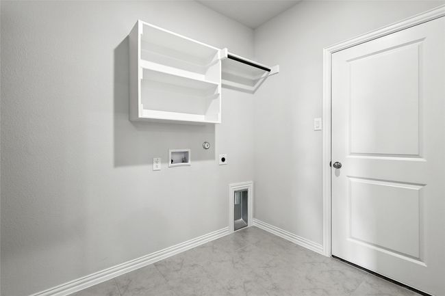 Laundry room with hookup for a gas dryer, electric dryer hookup, washer hookup, and marble finish flooring | Image 26