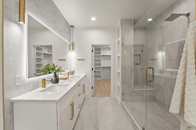Bathroom with double vanity, a spacious closet, a shower stall, and recessed lighting | Image 15