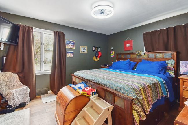 Bedroom with wood finished floors | Image 11