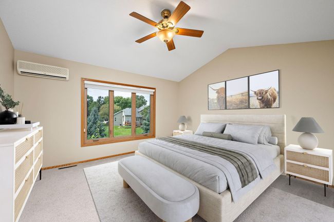 Owners' Suite with vaulted ceiling, walk-in closet and backyard views. | Image 16