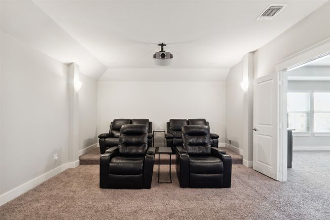 Carpeted home theater featuring baseboards | Image 32