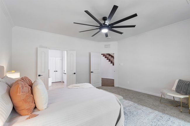 Carpeted bedroom featuring visible vents, ceiling fan, crown molding, and baseboards | Image 16