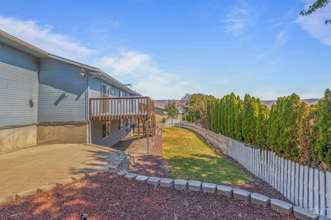 Fenced backyard featuring a deck and a patio | Image 41