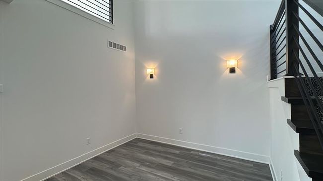 Unfurnished living room featuring baseboards, visible vents, and dark wood-style floors | Image 31