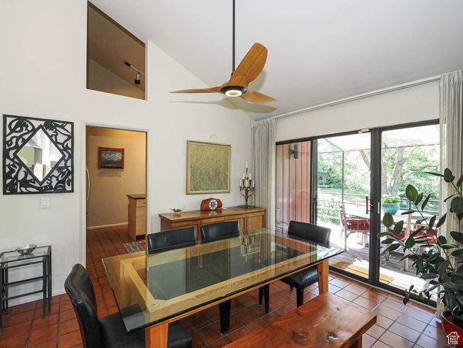 Dining space with lofted ceiling, tile patterned flooring, and ceiling fan | Image 13