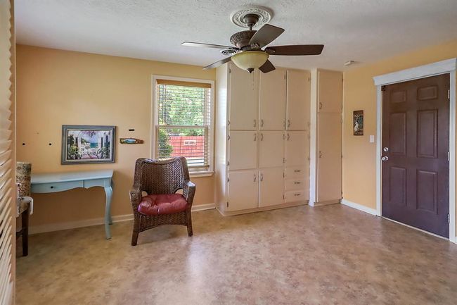 The mud room has an exterior rear door and built ins. | Image 17