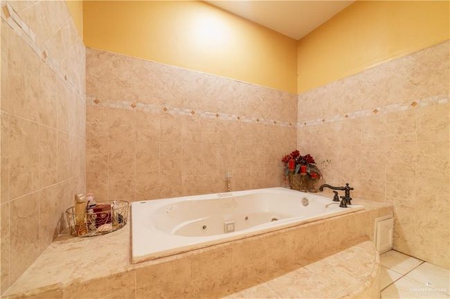 Bathroom with tile walls, a relaxing tiled tub, and tile patterned flooring | Image 25