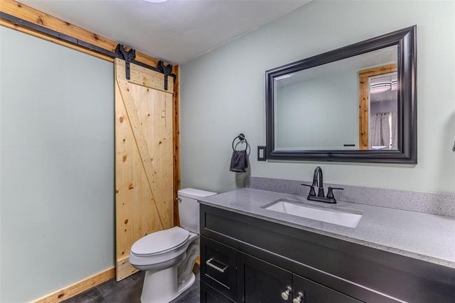 Bathroom with toilet, vanity, and wood finished floors | Image 23