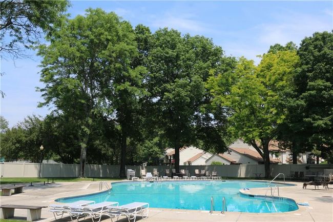 Pool with fence and a patio area | Image 11