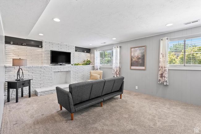 Living room with carpet flooring, recessed lighting, and a fireplace | Image 22