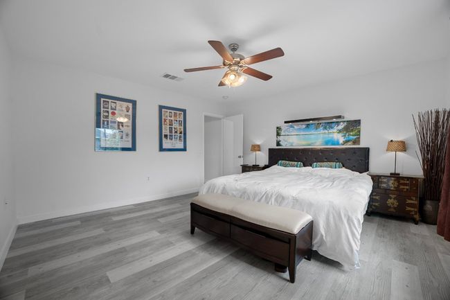 Bedroom with wood finished floors and ceiling fan | Image 21